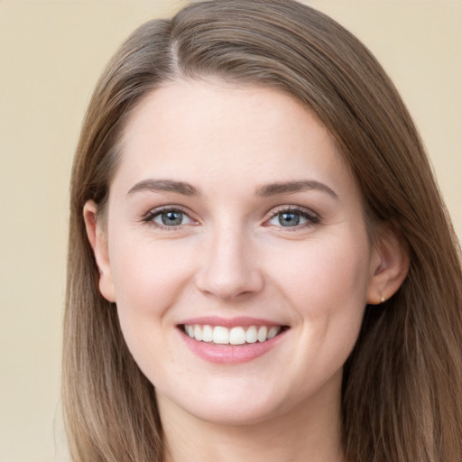 Joyful white young-adult female with long  brown hair and grey eyes