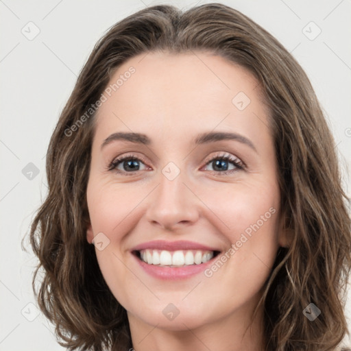 Joyful white young-adult female with long  brown hair and green eyes