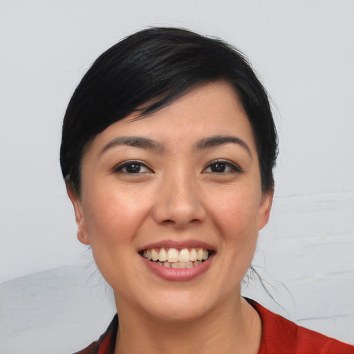 Joyful asian young-adult female with short  black hair and brown eyes