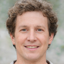 Joyful white adult male with short  brown hair and grey eyes