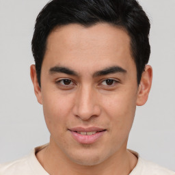 Joyful asian young-adult male with short  brown hair and brown eyes