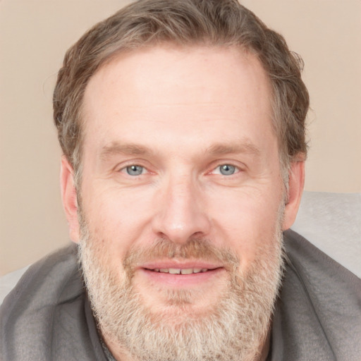 Joyful white adult male with short  brown hair and grey eyes