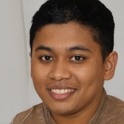 Joyful latino young-adult male with short  black hair and brown eyes