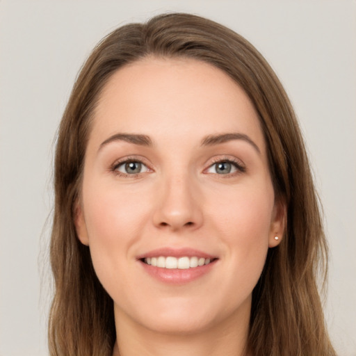 Joyful white young-adult female with long  brown hair and green eyes