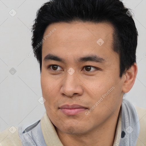 Joyful asian young-adult male with short  black hair and brown eyes