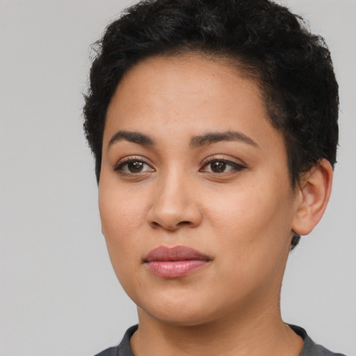 Joyful latino young-adult female with short  black hair and brown eyes