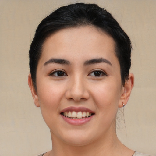 Joyful asian young-adult female with short  black hair and brown eyes