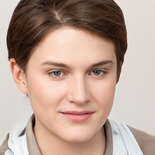 Joyful white young-adult female with short  brown hair and grey eyes