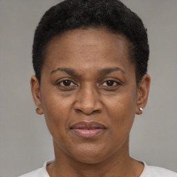 Joyful black adult female with short  brown hair and brown eyes