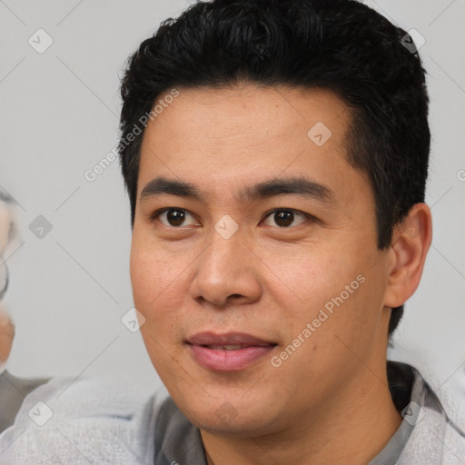 Joyful latino young-adult male with short  black hair and brown eyes