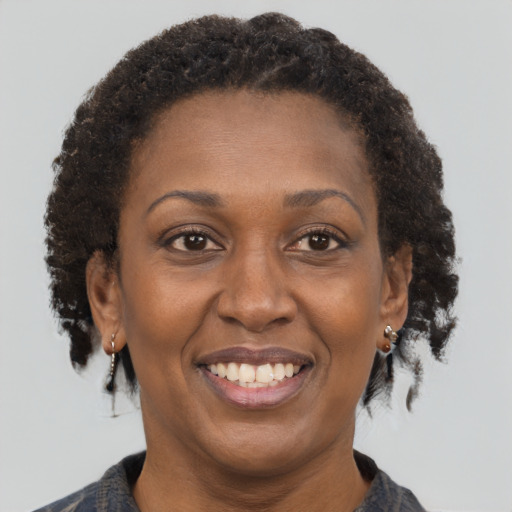 Joyful black adult female with short  brown hair and brown eyes