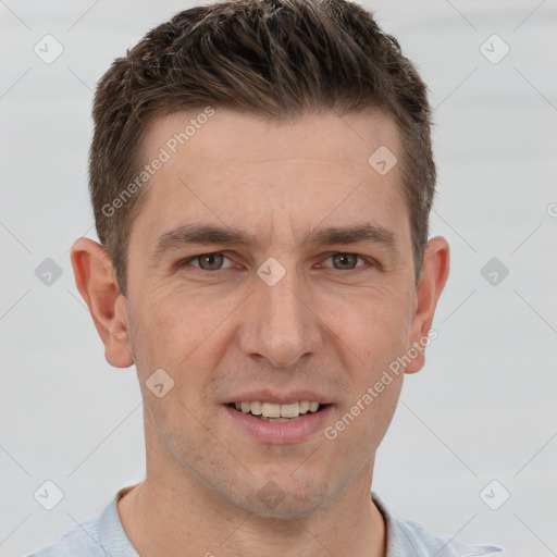 Joyful white adult male with short  brown hair and brown eyes