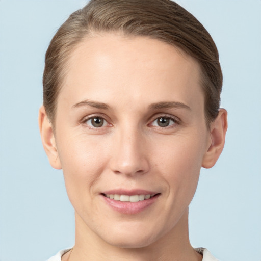 Joyful white young-adult female with short  brown hair and grey eyes