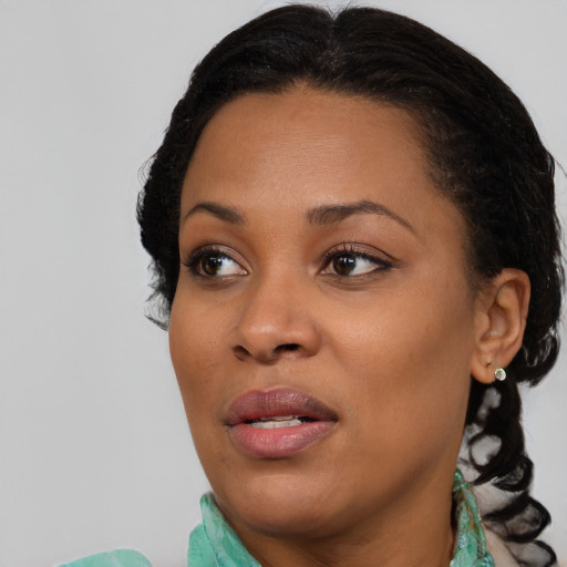 Joyful black young-adult female with medium  brown hair and brown eyes