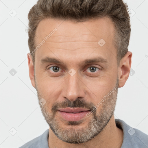 Joyful white adult male with short  brown hair and brown eyes