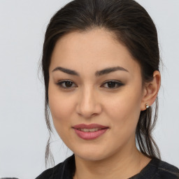 Joyful asian young-adult female with long  brown hair and brown eyes