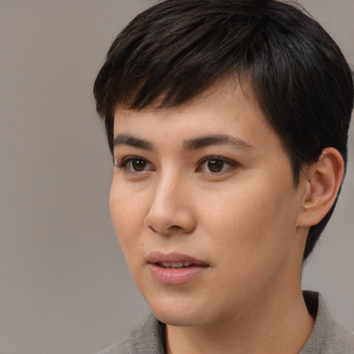 Joyful asian young-adult female with short  brown hair and brown eyes