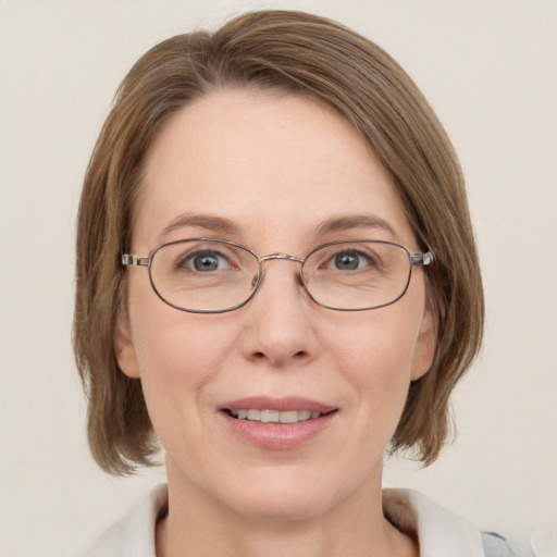 Joyful white adult female with medium  brown hair and grey eyes