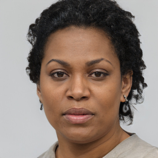 Neutral black adult female with short  black hair and brown eyes
