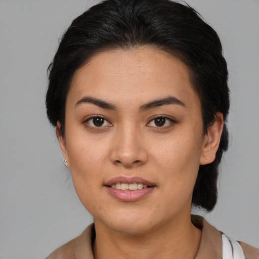 Joyful latino young-adult female with medium  brown hair and brown eyes