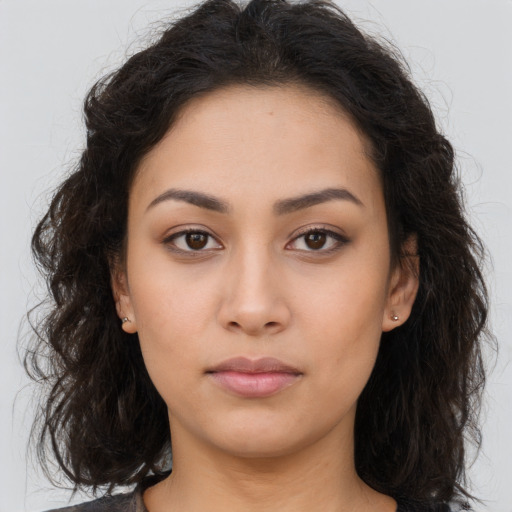 Neutral latino young-adult female with long  brown hair and brown eyes