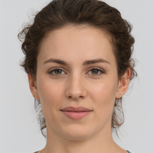 Joyful white young-adult female with medium  brown hair and green eyes