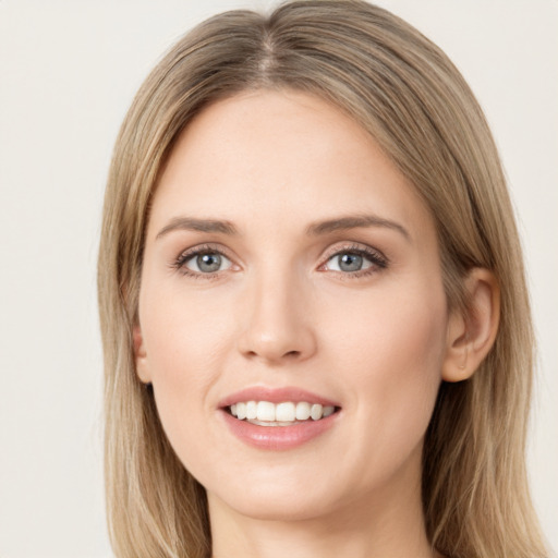 Joyful white young-adult female with long  brown hair and green eyes