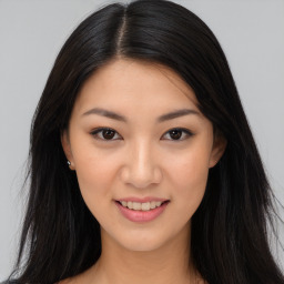 Joyful asian young-adult female with long  brown hair and brown eyes