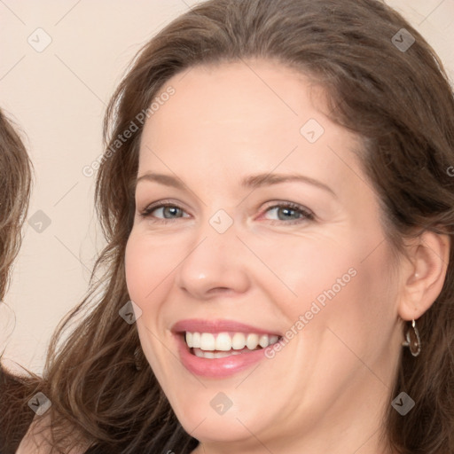 Joyful white adult female with long  brown hair and brown eyes