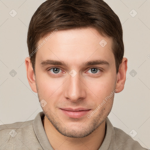 Joyful white young-adult male with short  brown hair and grey eyes