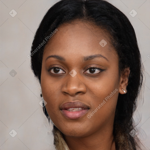 Joyful black young-adult female with long  black hair and brown eyes