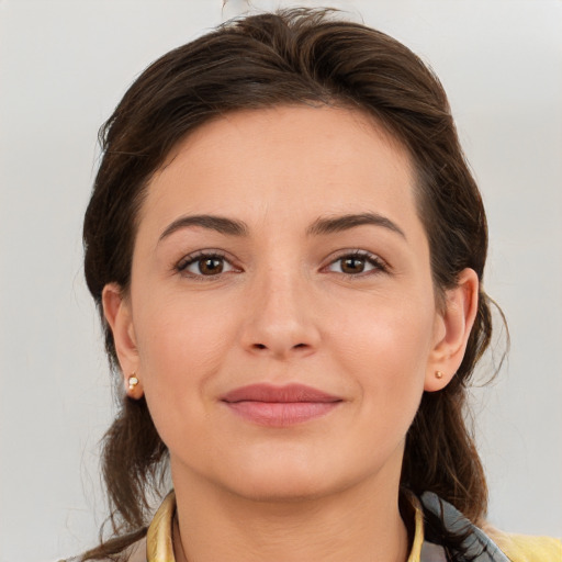 Joyful white young-adult female with medium  brown hair and brown eyes