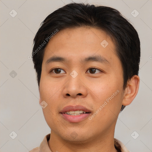 Joyful asian young-adult male with short  brown hair and brown eyes