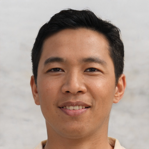 Joyful asian young-adult male with short  black hair and brown eyes
