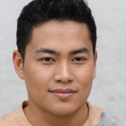 Joyful asian young-adult male with short  brown hair and brown eyes