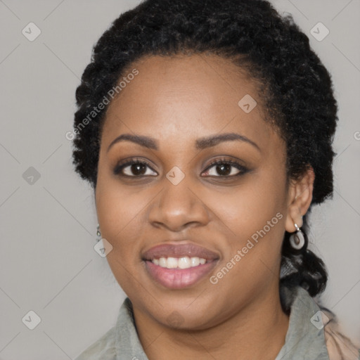 Joyful black young-adult female with long  black hair and brown eyes