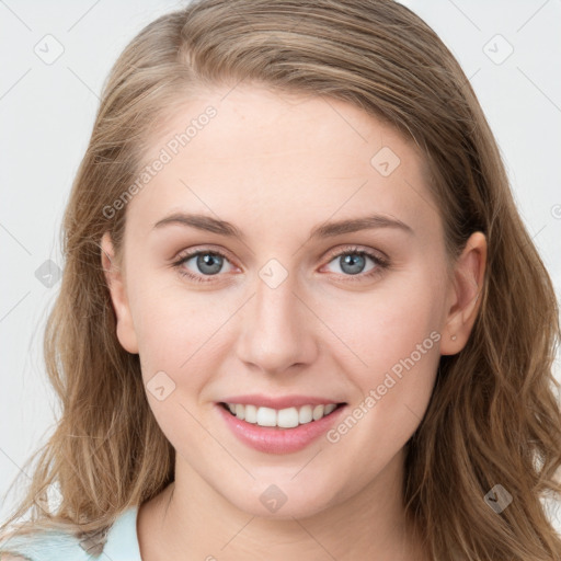 Joyful white young-adult female with long  brown hair and blue eyes