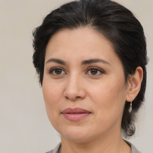 Joyful asian adult female with medium  brown hair and brown eyes
