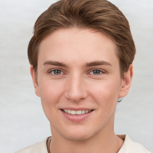 Joyful white young-adult female with short  brown hair and grey eyes