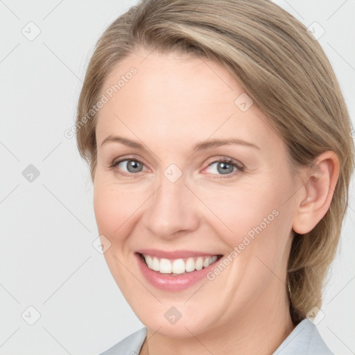 Joyful white young-adult female with medium  brown hair and grey eyes