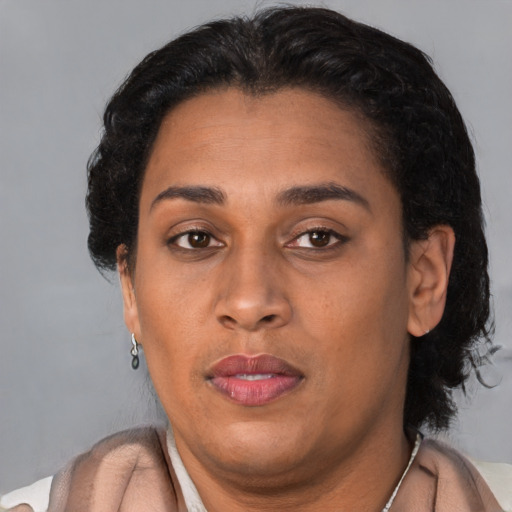Neutral latino adult female with short  brown hair and brown eyes