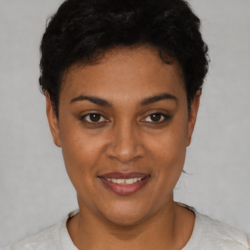 Joyful latino young-adult female with short  black hair and brown eyes