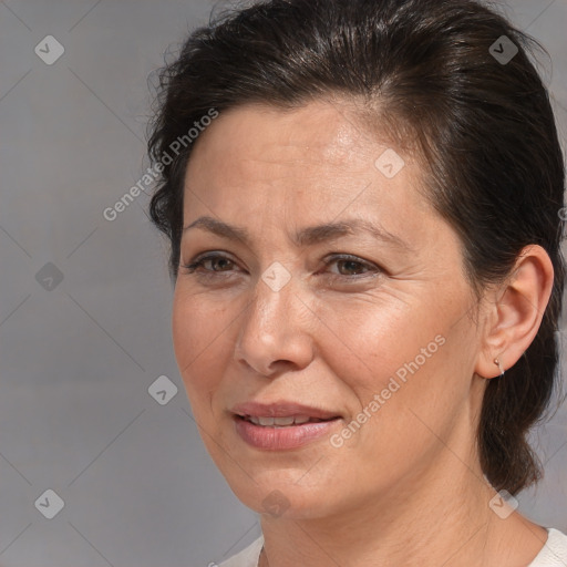 Joyful white adult female with medium  brown hair and brown eyes