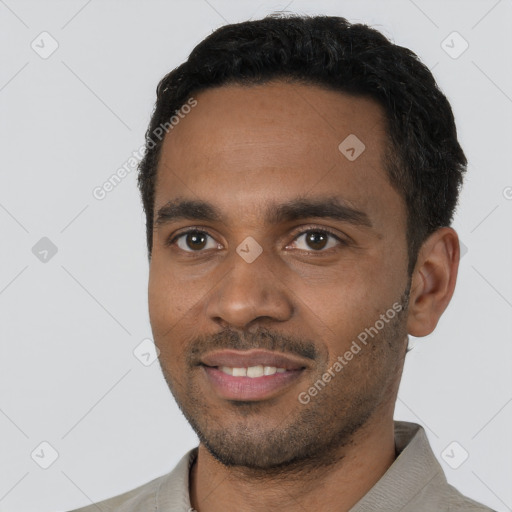 Joyful black young-adult male with short  black hair and brown eyes