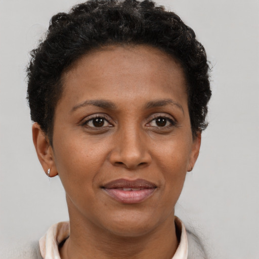 Joyful black adult female with short  brown hair and brown eyes