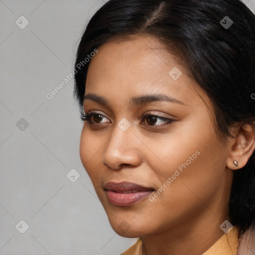 Joyful latino young-adult female with medium  brown hair and brown eyes