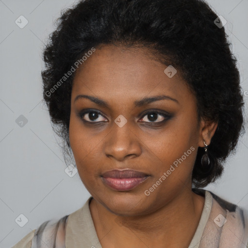 Joyful black young-adult female with long  black hair and brown eyes