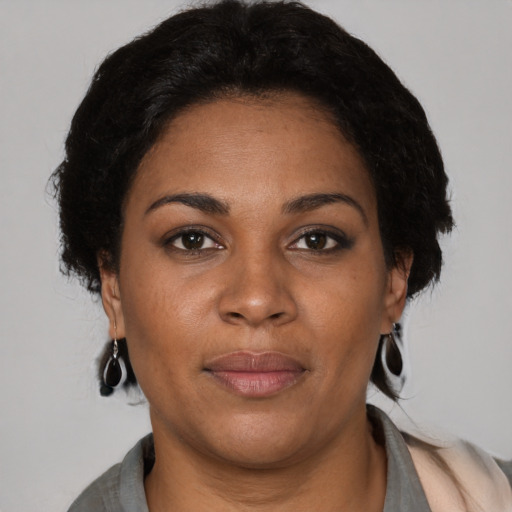 Joyful black young-adult female with medium  brown hair and brown eyes