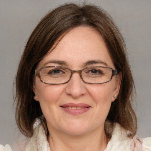 Joyful white adult female with medium  brown hair and blue eyes