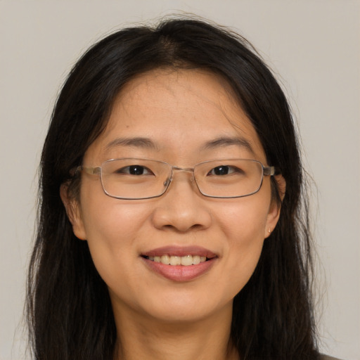 Joyful white adult female with long  brown hair and brown eyes